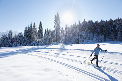 Germany, Bavaria, Isar Valley, Senior woman doing cross country skiing - MIRF000091