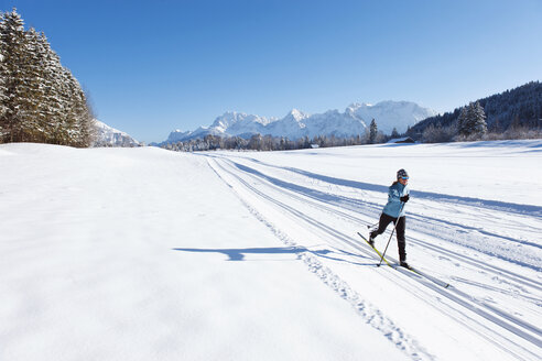 Deutschland, Bayern, Isartal, Seniorin beim Skilanglauf - MIRF000098