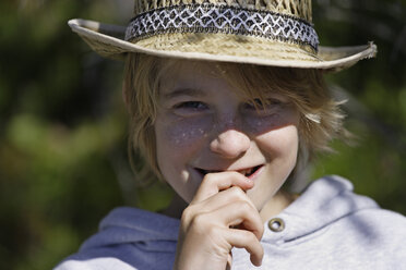 Germany, Upper Bavaria, Eibsee, Boy holding stick in mouth, portrait - TCF001417