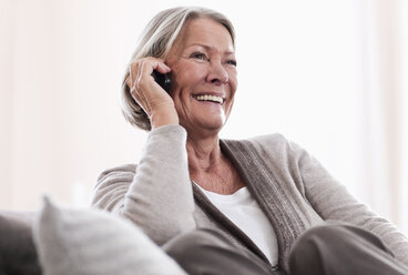 Germany, Wakendorf, Senior woman on the phone, smiling - WESTF016197