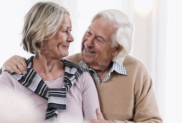 Germany, Wakendorf, Senior couple looking at each other, smiling - WESTF016223