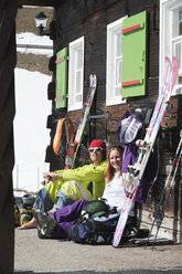 Austria, Kleinwalsertal, Couple relaxing outside mountain hut - MRF001251