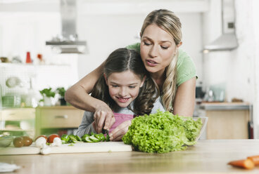 Germany, Cologne, Mother and daughter preparing salad - WESTF016297