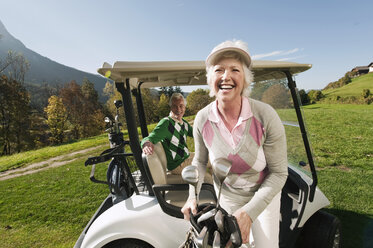 Italien, Kastelruth, Älteres Paar in Golfwagen auf Golfplatz, lächelnd - WESTF016421