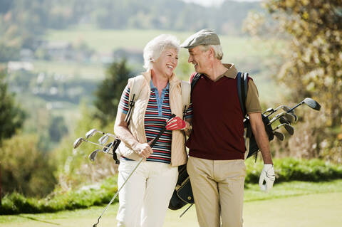 Italy, Kastelruth, Mature couple on golf course, smiling stock photo
