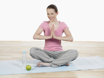 Young woman doing yoga, smiling, portrait - JLF000328