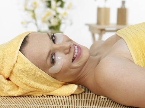 Young woman at spa, smiling, portrait stock photo