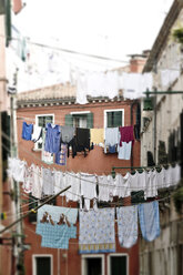 Italy, Venice, Laundry hanging on clothesline - MBEF000075