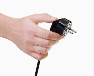 Human hand holding power cord, close-up - TSF000200