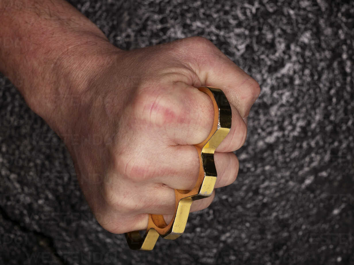 Fist with brass knuckles stock photo