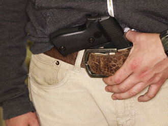Young man with gun in belt - AKF000239