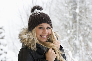 Austria, Teenage girl smiling, portrait - WWF001892