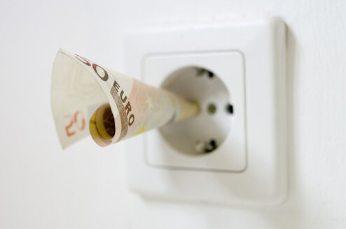 50 euro note kept into electrical socket, close up - MUF001024