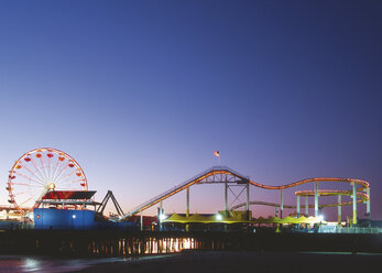 USA, California, Los Angeles, View of amusement park on the beach at evening - WBF000912