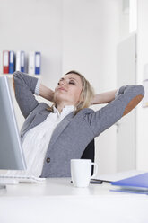 Germany, Bavaria, Munich, Businesswoman relaxing in office - RBF000491