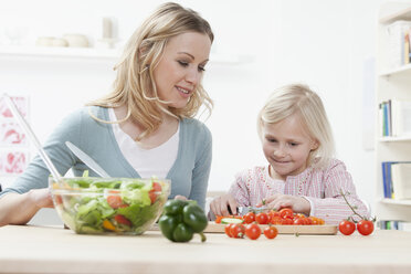 Germany, Bavaria, Munich, Mother and daughter preparing salad, smiling - RBF000559