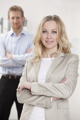 Germany, Bavaria, Munich, Businesswoman and businessman in office, smiling, portrait - RBF000577