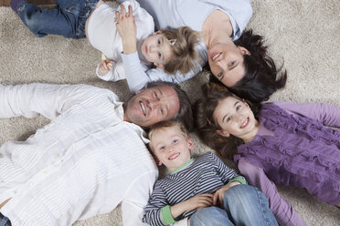 Germany, Bavaria, Munich, Family lying on floor, smiling - RBF000608