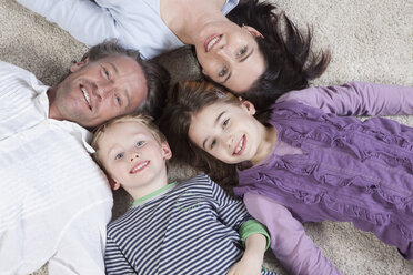 Germany, Bavaria, Munich, Family lying on floor, smiling - RBF000607