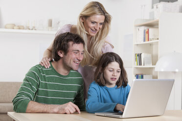 Germany, Bavaria, Munich, Family using laptop, smiling - RBF000659