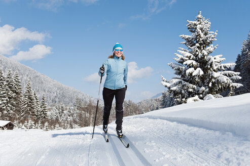 Germany, Bavaria, Aschermoos, Senior woman doing cross-country skiing - MIRF000103