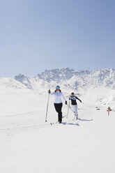 Italy, Trentino-Alto Adige, Alto Adige, Bolzano, Seiser Alm, Two women doing cross-country skiing - MIRF000168