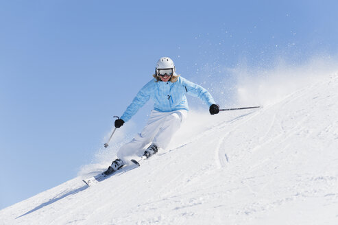 Italy, Trentino-Alto Adige, Alto Adige, Bolzano, Seiser Alm, Young woman skiing - MIRF000174