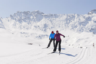 Italy, Trentino-Alto Adige, Alto Adige, Bolzano, Seiser Alm, Man and woman doing cross-country skiing - MIRF000197