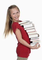 Girl carrying stack of books against white background - WWF001904