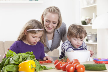 Germany, Bavaria, Munich, Mother, daughter and son preparing salad - RBF000683