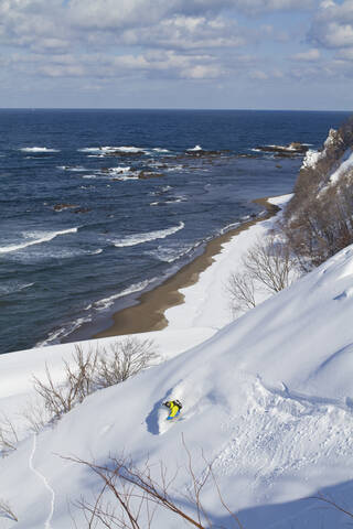 Japan, Hokkaido, Man doing telemark skiing stock photo