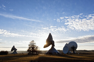 Germany, Bavaria, Raisting, View of antennas at earth station during dusk - FOF003372