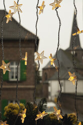 Germany, Cologne, Close up of illuminated stars as christmas window decoration - GWF001451