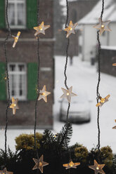 Germany, Cologne, Close up of illuminated stars as christmas window decoration - GWF001452