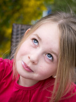 Germany, Bavaria, Close up of girl day dreaming, smiling - LFF000243