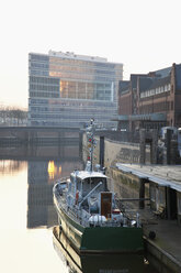 Germany, Hamburg, View of office building Deichtor and boat in foreground - MSF002463