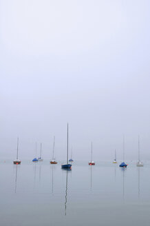 Germany, Bavaria, Ammersee, View of sailing boats in fog - MOF000159