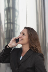 Germany, Cologne, Rheinauhafen, Close up of businesswoman on cell phone - GWF001464