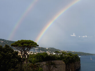 Southern Italy, Amalfi Coast, Piano di Sorrento, View of beautiful rainbow in sea with cliff in foreground - LFF000293