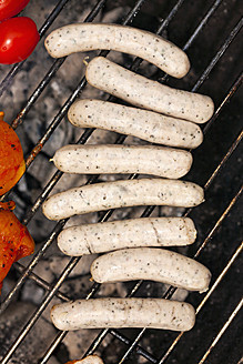 Germany, Bavaria, Close up of pork sausages on grill - TSF000275