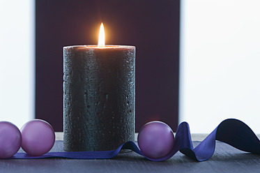 Close up of christmas baubles with ribbon and candle - ASF004362