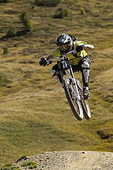 Italy, Livigno, View of man jumping with mountain bike - FFF001177