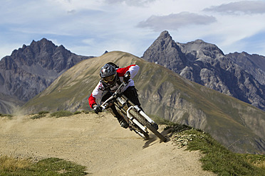 Italien, Livigno, Blick auf einen Mann, der mit seinem Mountainbike bergab fährt - FFF001179
