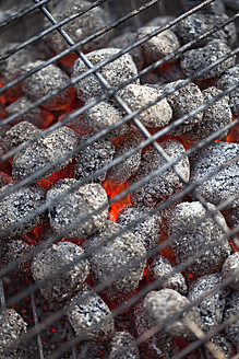 Germany, Burning coal briquettes of barbecue grill, close up - MAEF003416