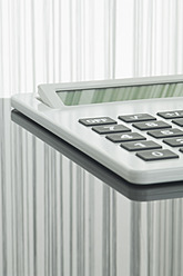 Close up of pocket calculator with reflection on table - ASF004373
