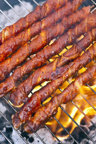 Begium, Mechelen, Close up of marinated meat roasting on barbecue grill stock photo