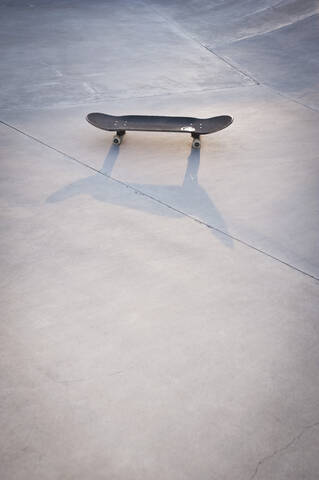 Belgium, Mechelen, Skateboard lying on ground in public skatepark stock photo