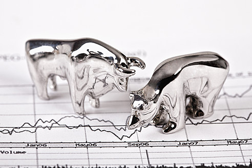 Close up of bear and bull figurine on stock chart - TSF000316
