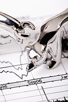 Close up of bear and bull figurine on stock chart - TSF000315