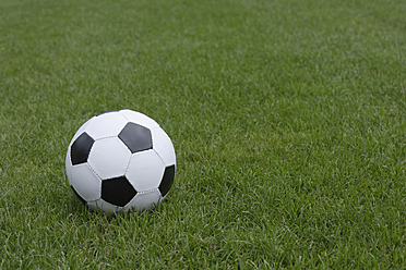 Germany, Icking, Close up of football on grass - TCF001609